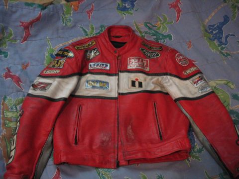 2005 Yamaha R1 - A red and white leather motorcycle jacket is displayed with various sponsor patches.