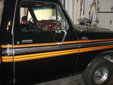 1979 Ford F-150 - This black Ford F-150 pickup features a distinctive orange stripe package along its side.