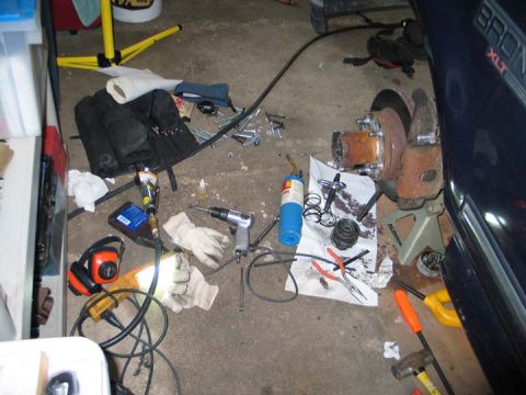 1994 Ford Bronco - Tools and parts are scattered around the disassembled hub of a 1994 Ford Bronco XLT.