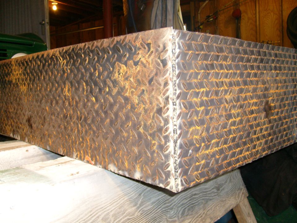 Diamond plate toolbox with rust and weld marks