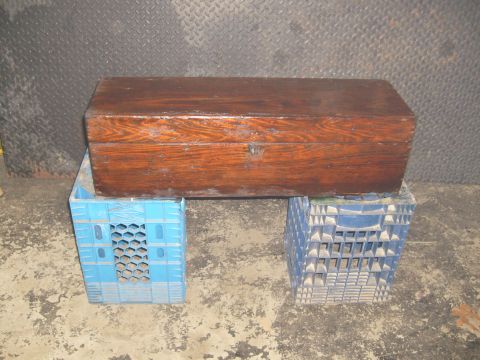 1974 Ford Bronco - A wooden chest rests on two milk crates in front of a diamond plate wall.
