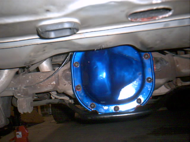 Underbody view of a rear axle with a blue-painted differential cover