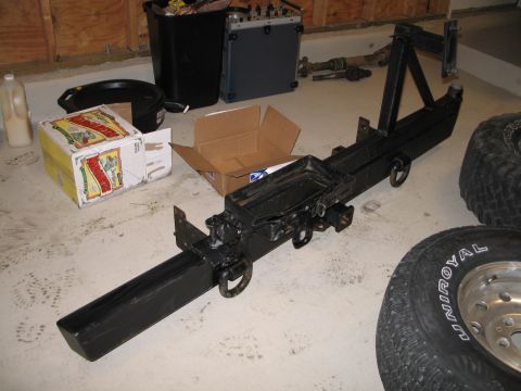 1995 Ford Bronco - A black rear bumper assembly, likely for an SUV or truck, is shown with a spare tire mount and tow hitch.