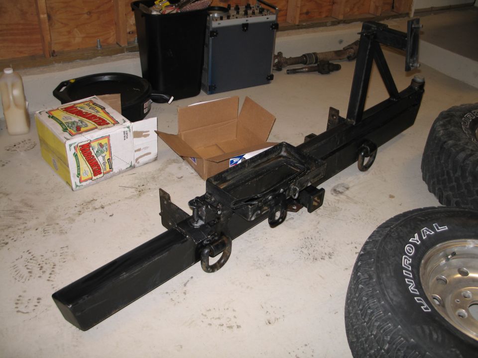 Black rear bumper with spare tire mount and tow hitch receiver