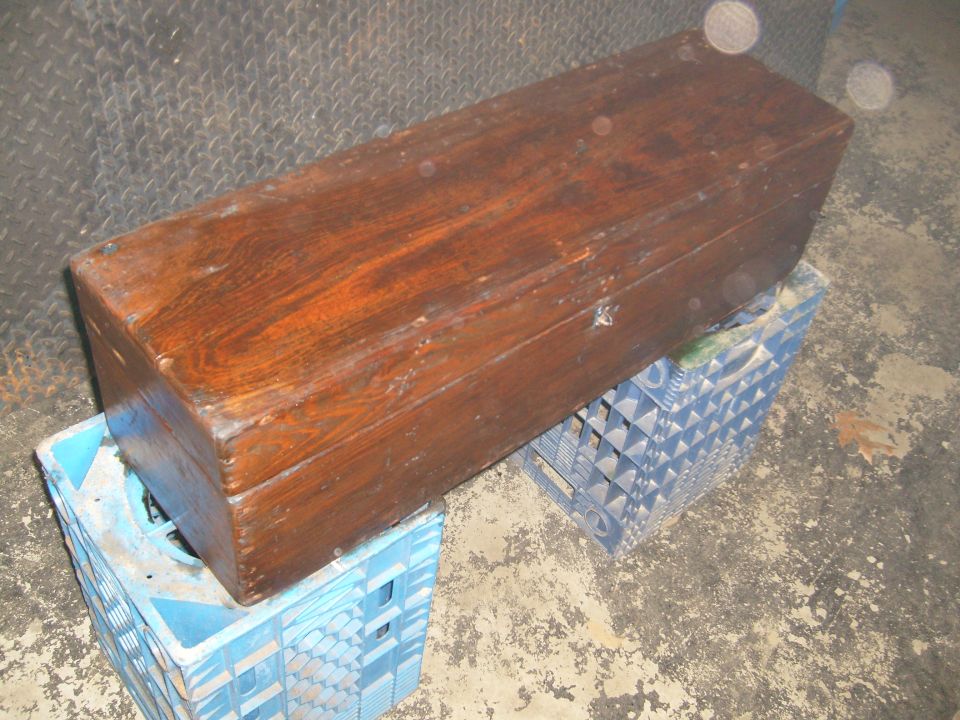 Wooden chest sitting on two blue plastic crates