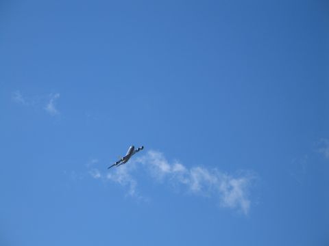 1995 Ford Bronco - An airplane is seen in the sky, leaving a contrail.