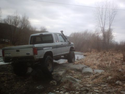 1990 Ford Ranger - This 1990 Ford Ranger is equipped for off-road adventures, navigating a rocky stream bed.