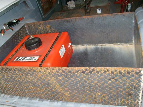 1974 Ford Bronco - An orange fuel tank sits inside a custom metal box, with a can of spray paint nearby.