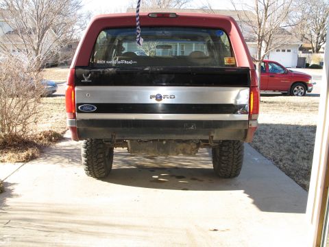 1995 Ford Bronco - The rear of a Ford Bronco shows its taillights, Ford badging, and a sticker that says "RICK NAKED OFF-ROAD".