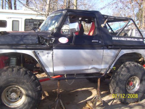 1978 Ford Bronco - This modified 1978 Ford Bronco features a roll cage and is elevated on jack stands for maintenance or display.