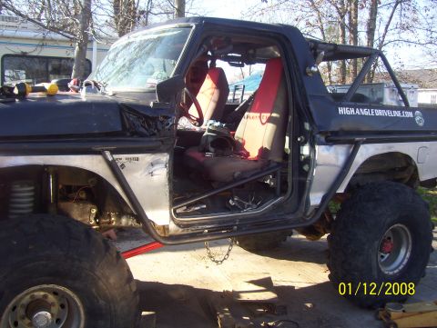 1978 Ford Bronco - Modified 1978 Ford Bronco interior shows custom roll cage and red seats.