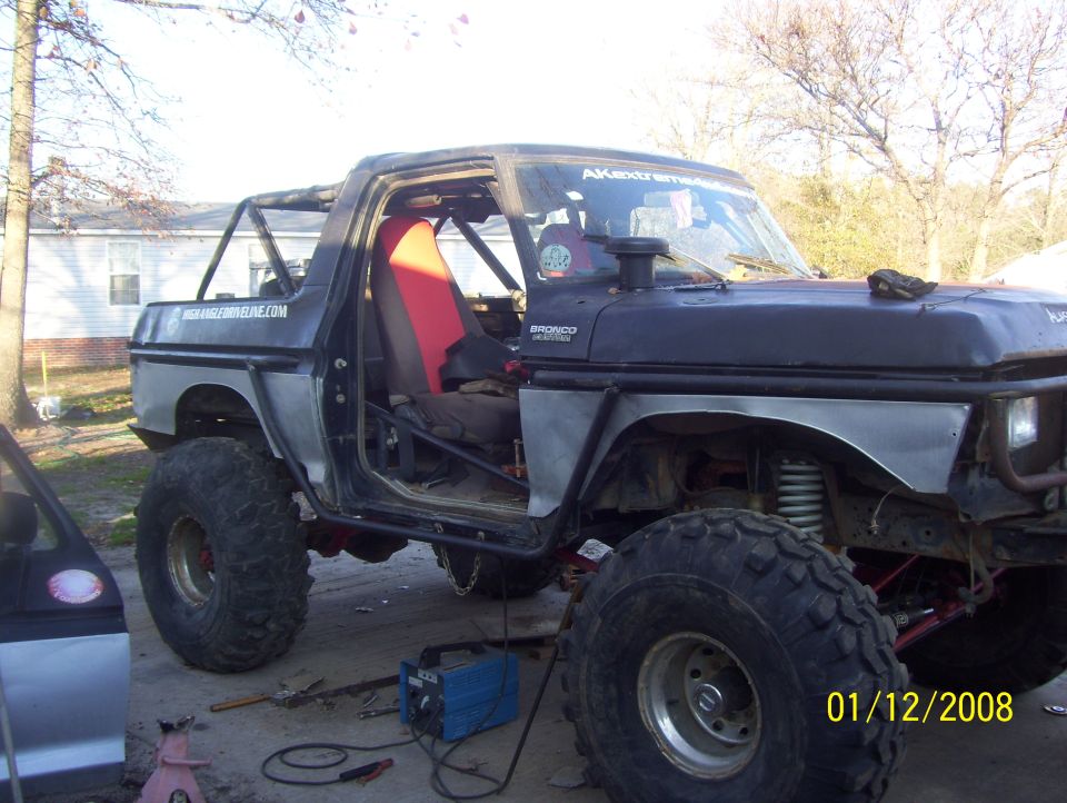 Modified 1978 Ford Bronco interior with racing seat and roll cage