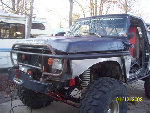 1978 Ford Bronco - Custom off-road truck with extensive modifications, including a roll cage and heavy-duty bumper.