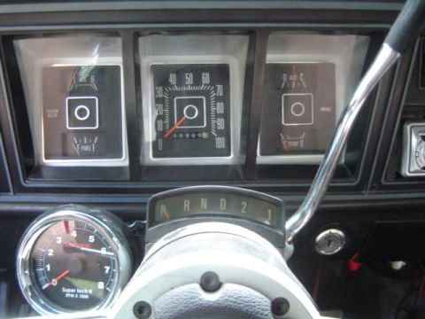 1979 Ford Bronco - The interior of a 1979 Ford Bronco shows a dashboard with various gauges, including a speedometer and tachometer.