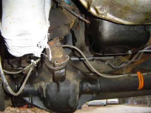 1979 Ford Bronco - Underside view of vehicle components including the rear axle and transmission oil pan.