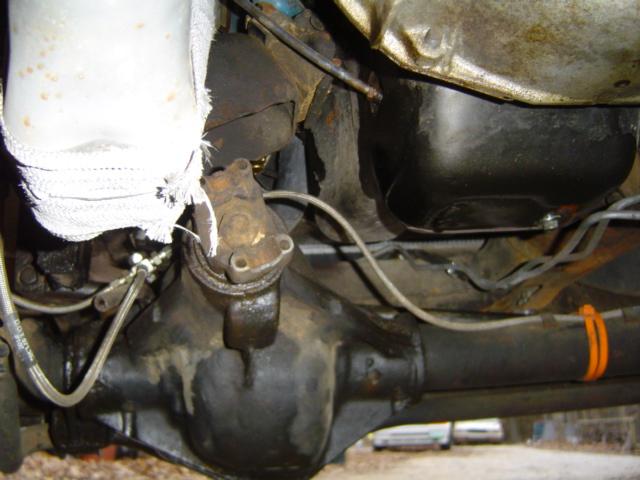 Underside of vehicle showing rear axle assembly and transmission oil pan