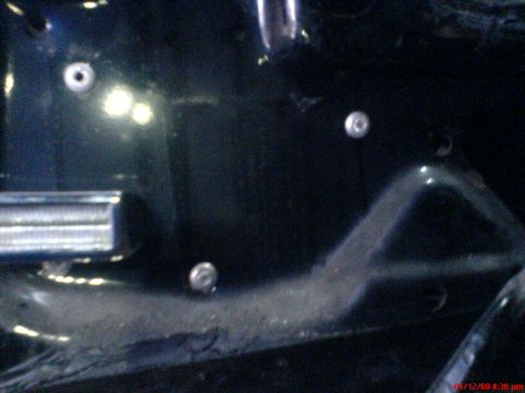 1986 Ford Bronco - Close-up view of an interior door panel, showing mounting points and a section of trim.