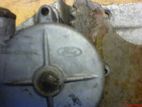 1986 Ford Bronco - A close-up shows a metal component with the Ford logo embossed on its surface.