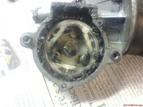 1986 Ford Bronco - The inside of a starter motor shows significant wear and accumulated grease.