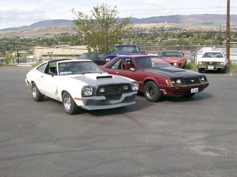 1978 Ford Mustang II - A white and gray 1974-1978 Ford Mustang II is parked in a lot with other vehicles.