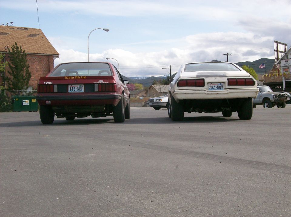 1978 Ford Mustang II and a white car from the rear