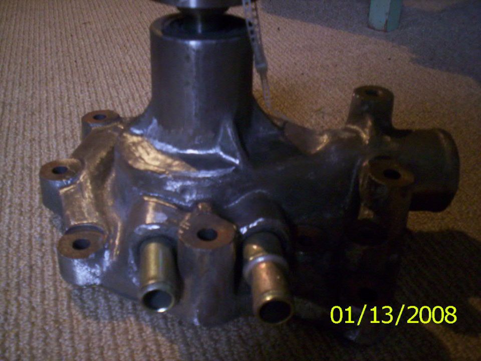 Water pump with multiple hose connections and a pulley shaft
