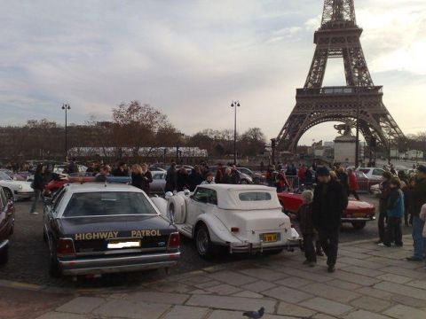 1991 Ford Crown Victoria - A 1991 Ford Crown Victoria police car is parked with other vehicles near the Eiffel Tower.