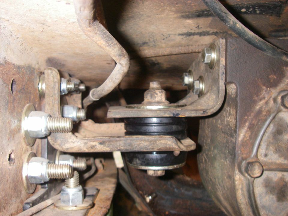 Close-up of a modified suspension mount with rubber isolators