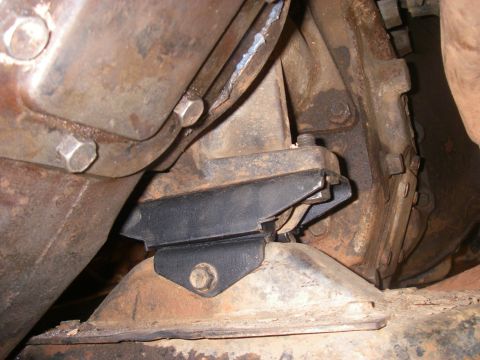1978 Ford Bronco - Underside view of a vehicle's transmission mount bracket.