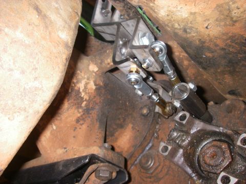 1978 Ford Bronco - Close-up of custom transfer case linkage modification, showing mechanical components and rusty metal.