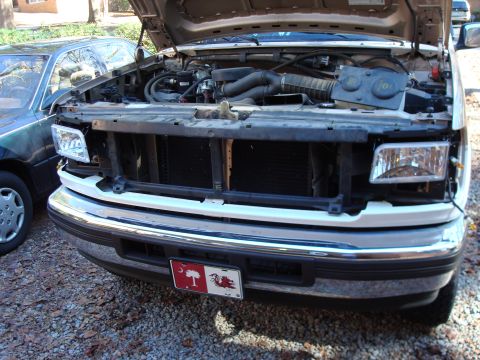 1992 Ford Bronco - Front view of a 1992 Ford Bronco with the hood open, revealing the engine compartment.