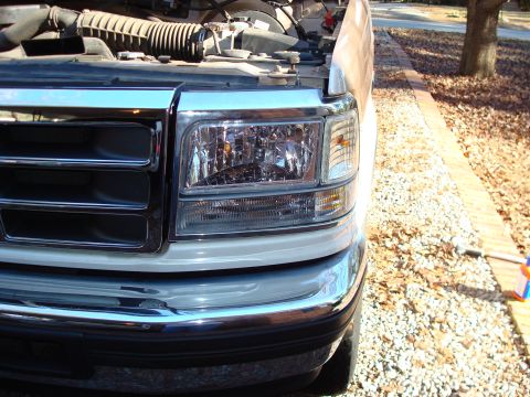 1992 Ford Bronco - Front view of a 1992 Ford Bronco, showing the grille and headlight assembly with the hood open.