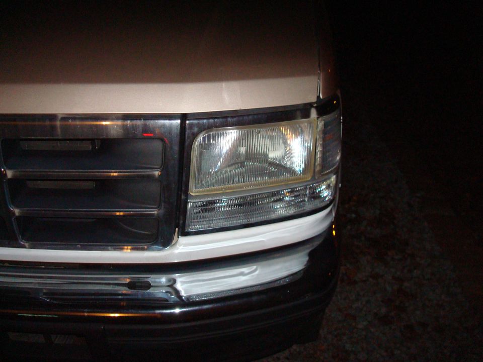 Close-up of a 1992 Ford F-Series truck's grille and headlight