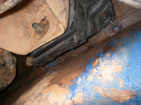 1978 Ford Bronco - Close-up view of a vehicle's engine mount and rusty chassis, with "Supermotors.net" visible at the bottom.