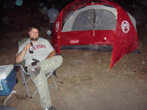 1992 Ford Bronco - A man enjoys a beer while camping next to a red tent.