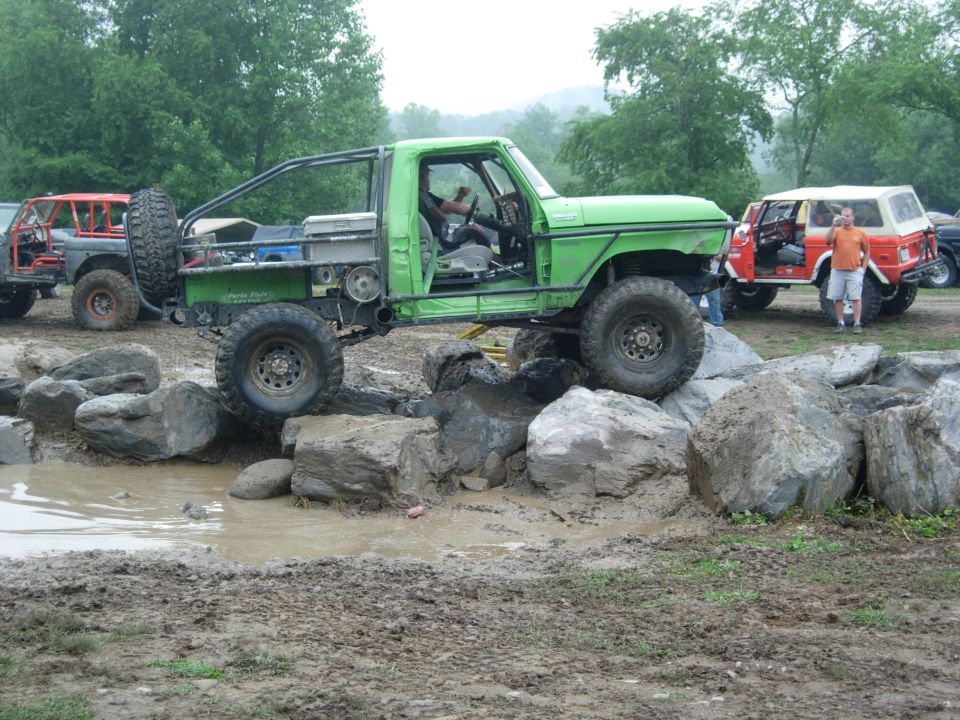 Green 1978 Ford Bronco modified for off-roading, side view