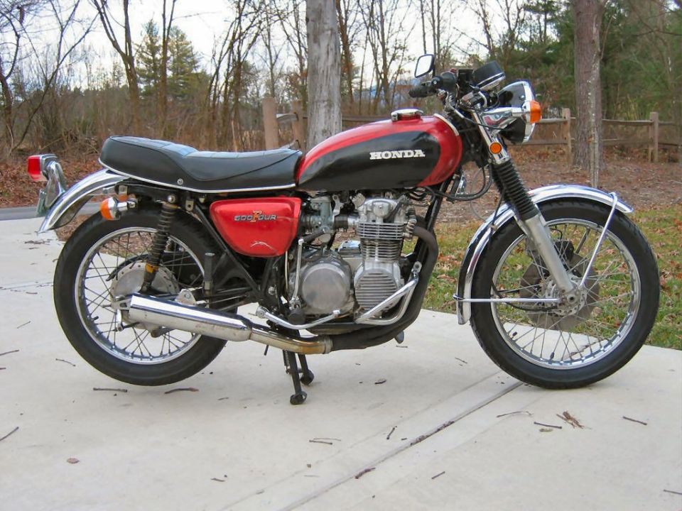 Red and black Honda motorcycle with chrome accents parked on a concrete surface