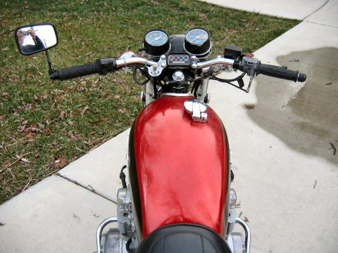 1985 Ford LTD Crown Victoria - The image shows the top view of a red motorcycle's gas tank and handlebars, with dual gauges visible.