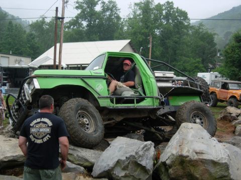 1978 Ford Bronco - Modified 1978 Ford Bronco tackling a rocky obstacle course with a second Bronco in the background.