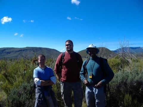 1992 Ford Bronco - Three hikers pose for a photo in a scenic outdoor location with mountains in the background.