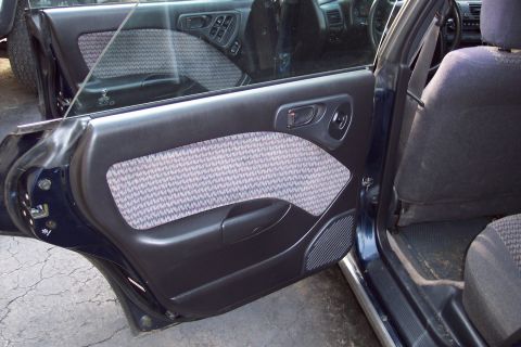 2001 Ford Crown Victoria - Close-up of a car's interior door panel and part of the back seat.