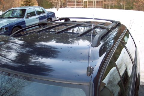 2001 Ford Crown Victoria - Two vehicles parked outside in a snowy environment. One is a 2001 Ford Crown Victoria.