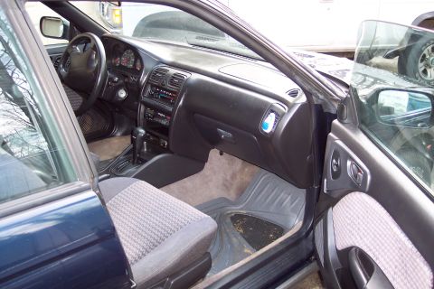 2001 Ford Crown Victoria - The interior of a dark blue car, showing the dashboard, steering wheel, and front seats.