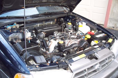 2001 Ford Crown Victoria - The engine bay of a Subaru is shown with the hood open, revealing the engine and various components.