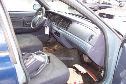 2001 Ford Crown Victoria - The interior of a 2001 Ford Crown Victoria, the dashboard, steering wheel, and seats.