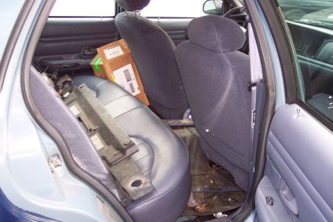 2001 Ford Crown Victoria - Rear interior view of a 2001 Ford Crown Victoria, with boxes and parts visible.