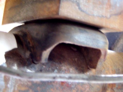 1996 Ford Bronco - A detailed view of a worn and rusted vehicle suspension component.