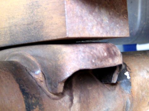 1996 Ford Bronco - A close-up view of a vehicle's driveshaft U-joint, showing signs of rust and wear.