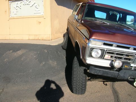 1979 Ford Bronco - Front suspension detail of a brown 1979 Ford Bronco.