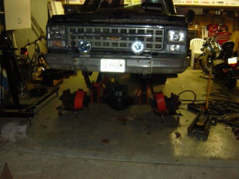 1987 Suzuki Samurai - Front end of a Chevrolet C/K truck, likely from the 1973-1980 model range, undergoing maintenance.